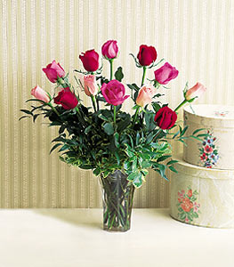 A dozen multi-colored roses in a vase